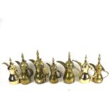 Five vintage Middle Eastern brass coffee pots and two contemporary stainless steel examples. Max.