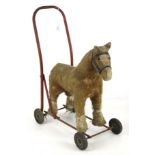 A vintage child's Mule on wheels.