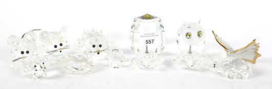 An assortment of Swarovski and cut glass and ceramic paperweights.