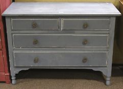 A blue painted chest of drawers. Two short over two long drawers.