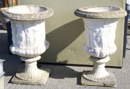 A pair of white stone garden urns.