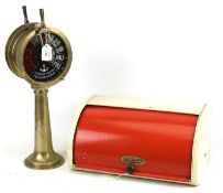 A vintage enamel bread bin and model ships brass telegraph.