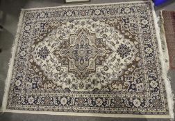 A Persian style contemporary rug. On a cream ground with brown and blue geometric decoration.