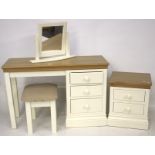 A contemporary ensuite dressing table, stool, mirror and bedside cabinet.