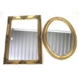 Two contemporary bevelled edge and gilt framed wall mirrors.