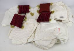 A box of table linen and textiles. Including tablecloths, place mats, miniature cushions, etc.