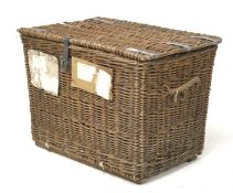 A large vintage wicker laundry storage hamper. With metal strapping and clasp.