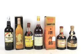 A collection of seven assorted bottles of spirits.