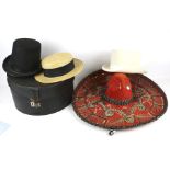 Three hats, a sombrero and a hat box.
