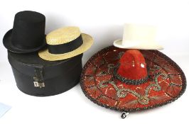 Three hats, a sombrero and a hat box.