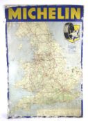 A vintage tin and an enamel 'Michelin Motoring Map' advertising sign.