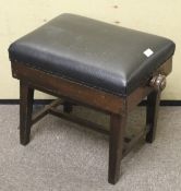 A 20th century mahogany adjustable piano stool.