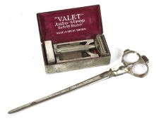 A pair of tailors measuring scissors and a gentleman's safety razor.