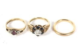 A 9ct gold wedding band and two 9ct gold dress rings. The wedding band, 2.