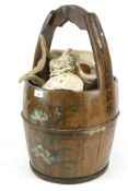 A Chinese wooded well bucket containing a large quantity of seashells.