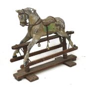 An early 20th century carved wooden rocking horse.