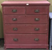 A burgundy painted pine chest of drawers. Two short over three long drawers.
