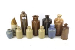 A collection of eleven assorted vintage stoneware bottles. Including The Winchester Brewery Co. Ltd.