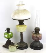 Four Victorian and later oil lamps.