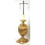 A contemporary gilt plaster table lamp. Of fluted baluster form on a square plinth.