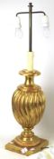 A contemporary gilt plaster table lamp. Of fluted baluster form on a square plinth.