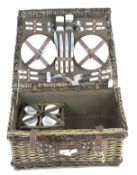 A contemporary picnic set within a wicker basket.