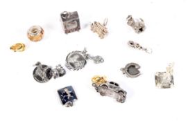 Fifteen assorted silver charms. Includin