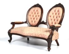 A Victorian carved mahogany two-seat parlor sofa.