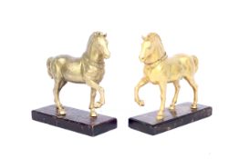 A pair of gilt metal models of horses on