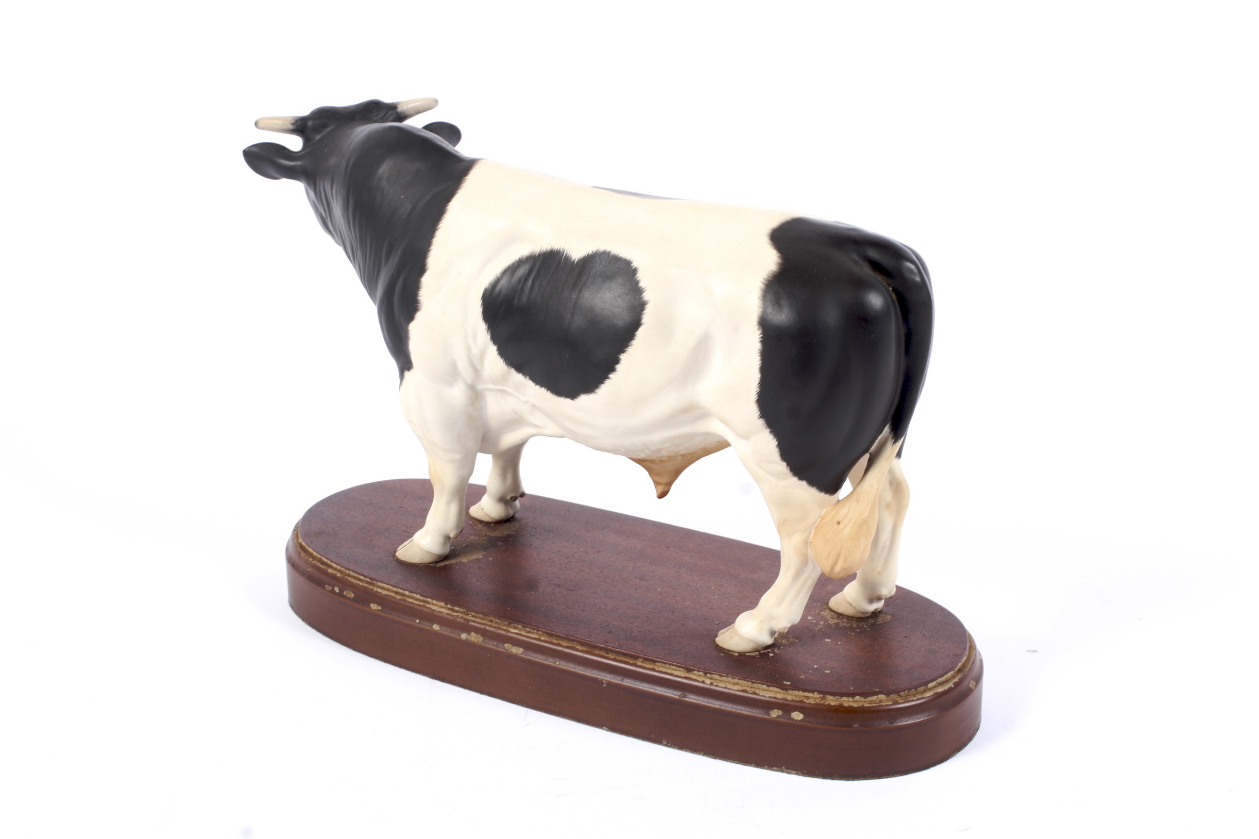 A Royal Doulton model of a Fresian Bull on an inscribed wooden base. Printed black marks, 29. - Image 2 of 2