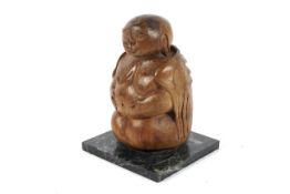 A vintage carved wooden seated Buddha on