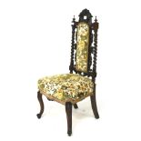 A Victorian heavily carved upholstered d