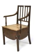 A Victorian oak commode chair. Raised on