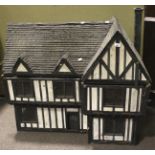 A Tudor style half-timbered dolls house.