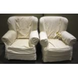 A pair of vintage wingback armchairs wit