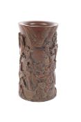 A carved resin Chinese brush pot with spruce pine decoration, ferns and the 7 immortals as figures,