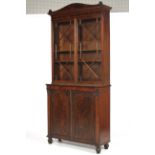 A Regency Strung and crossbanded Mahogany Bookcase on Cabinet,