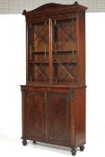 A Regency Strung and crossbanded Mahogany Bookcase on Cabinet,