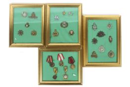 Military Medals and Cap Badges - Three frames containing military cap badges to include Dorsetshire,