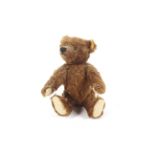 A late 20th Century dark finish Steiff Teddy bear ( wool and cotton covering with jointed arms and