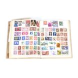 A world collection of stamps in one album and with several loose stamps