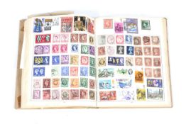 A world collection of stamps in one album and with several loose stamps
