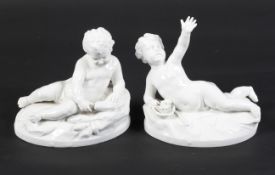 A 19th century German pair of ceramic reclining male chrubs entitled 'LUFT' (air) and ' WASSER'