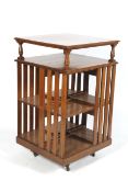 A Victorian Golden Oak Revolving bookcase with open under tier to top,
