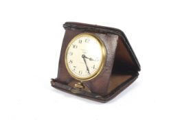 A 1930's Travelling and folding Waltham 8 day clock in a pig skin case with winder at 6,