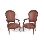 A pair of Victorian style Mahogany open arm chairs with brass stud and faux leather (vinyl)
