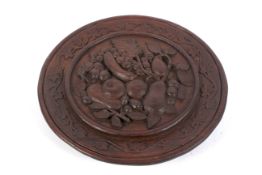 A late 19th/early 20th century carved wooden wall plaque.