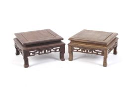 A pair of circa 1900 hardwood Chinese square form stands, 9 .5 cm high x 16.