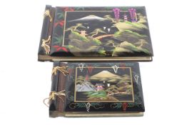 Two lacquered photo albums, circa 1956-57, mounted with images of Hong Kong and military interest.