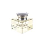 An Asprey & Co silver and tortoiseshell mounted glass inkwell.